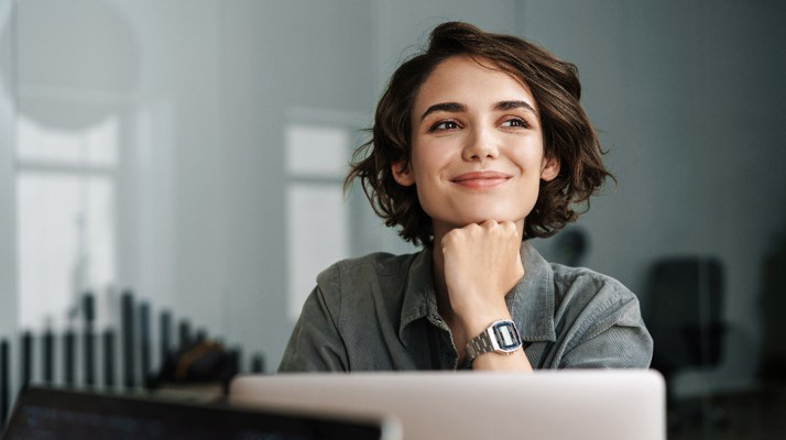 A woman on her laptop looking away from the camera