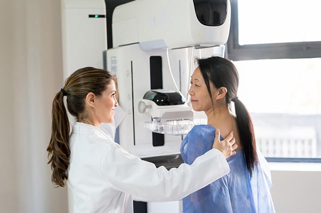 Impact Insider, October 2026 shows a care worker helping a woman get a breast scan.