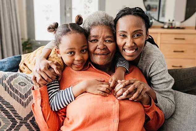 woman hugging daughter and granddaughter 