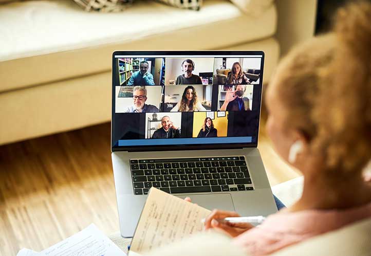 woman watching webinar on laptop