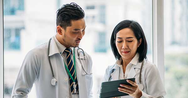 two doctors looking at an ipad